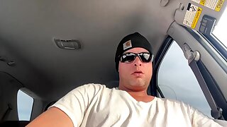 He shows off his bushy hard cock in his SUV and leaks precum