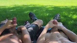 Two lads cumming near a busy road