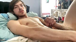 He shows off his hairy hole and bushy cock and cums on his stomach